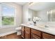 Well-lit bathroom showcasing a double sink vanity and large window overlooking greenery at 19534 Forsythe Dr, Noblesville, IN 46060