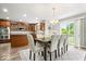 Bright dining room with chandelier, seating for eight, and views to the kitchen at 19534 Forsythe Dr, Noblesville, IN 46060