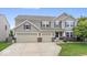Charming two-story home with a three-car garage and well-manicured lawn at 19534 Forsythe Dr, Noblesville, IN 46060