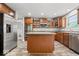 This is a kitchen with stainless steel appliances, an island, and wood cabinets at 19534 Forsythe Dr, Noblesville, IN 46060