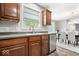 Kitchen sink with stainless steel dishwasher looking into the dining area at 19534 Forsythe Dr, Noblesville, IN 46060