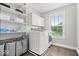 Functional laundry room with modern washer, ample shelving, and natural light at 19534 Forsythe Dr, Noblesville, IN 46060