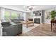 Cozy living area with large windows, fireplace, and stylish grey sectional sofa at 19534 Forsythe Dr, Noblesville, IN 46060