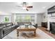 Spacious living room with a large sectional sofa, fireplace and streaming natural light at 19534 Forsythe Dr, Noblesville, IN 46060