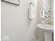 Powder room featuring a pedestal sink, chrome faucet, and decorative mirror at 19534 Forsythe Dr, Noblesville, IN 46060