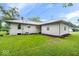 Back exterior view of the home shows the siding, windows, and well-kept lawn at 2105 Mayfair Dr, Indianapolis, IN 46260