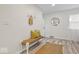 Bright entryway features stylish bench seating, hooks, and wood laminate flooring at 2105 Mayfair Dr, Indianapolis, IN 46260