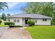 Charming one-story home with a well-manicured lawn and inviting curb appeal at 2105 Mayfair Dr, Indianapolis, IN 46260