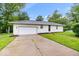 Charming single-story home featuring an attached garage, well-maintained lawn, and inviting entrance at 2105 Mayfair Dr, Indianapolis, IN 46260
