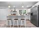 Modern kitchen features a center island with seating, stainless steel appliances, and stylish lighting at 2105 Mayfair Dr, Indianapolis, IN 46260