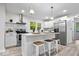 Bright kitchen with stainless steel appliances, island, and sleek white cabinets at 2105 Mayfair Dr, Indianapolis, IN 46260