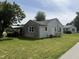 Exterior view of a single-story home featuring a stone accent, siding, and a well-maintained lawn at 222 Hanley St, Plainfield, IN 46168