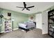 Cozy bedroom featuring a black ceiling fan, bright green walls, and a plush bed at 241 Liberty Blvd, Mooresville, IN 46158