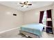 This bedroom features a bed, curtains, and is brightly illuminated by a ceiling fan at 241 Liberty Blvd, Mooresville, IN 46158