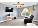 This bright bedroom has a television, desk, guitar, and a recliner at 241 Liberty Blvd, Mooresville, IN 46158