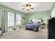 Bedroom with light green paint, carpeted floor, and natural light from the bright windows at 241 Liberty Blvd, Mooresville, IN 46158