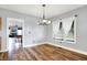 Bright dining room with hardwood floors and view into the living room and kitchen at 241 Liberty Blvd, Mooresville, IN 46158