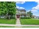 Charming two-story home with a manicured lawn and inviting red front door at 241 Liberty Blvd, Mooresville, IN 46158
