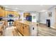Spacious kitchen featuring wood-style flooring, stainless steel appliances, a kitchen island, and wooden cabinets at 241 Liberty Blvd, Mooresville, IN 46158