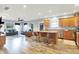 Open kitchen with stainless appliances, island with bar stool seating, and view into the spacious living room at 241 Liberty Blvd, Mooresville, IN 46158