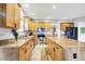 Bright kitchen featuring wood-style flooring, stainless steel appliances, a kitchen island, and wooden cabinets at 241 Liberty Blvd, Mooresville, IN 46158