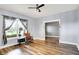 Bright living room with hardwood floors, ceiling fan, and large window at 241 Liberty Blvd, Mooresville, IN 46158