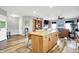 Open concept living space with wood-style flooring and a kitchen island with seating at 241 Liberty Blvd, Mooresville, IN 46158