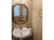 Bright bathroom featuring a pedestal sink, octagonal mirror, and neutral decor for a clean, fresh feel at 2445 N Delaware St, Indianapolis, IN 46205