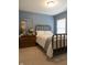 Bedroom with natural lighting, carpeted floor and a brass bed at 2445 N Delaware St, Indianapolis, IN 46205