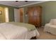 Bedroom features large wardrobe, patterned chair and carpeted flooring at 2445 N Delaware St, Indianapolis, IN 46205