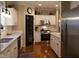 Spacious kitchen featuring white cabinets, granite countertops, stainless steel appliances, and hardwood floors at 2445 N Delaware St, Indianapolis, IN 46205