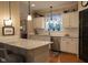 Modern kitchen with white cabinets, granite countertops, stainless steel appliances and hardwood floors at 2445 N Delaware St, Indianapolis, IN 46205