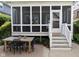 Relaxing outdoor patio with table and seating, and stairs to the screened-in porch at 2445 N Delaware St, Indianapolis, IN 46205