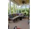Bright sunroom with large windows, ceiling fan and neutral furniture at 2445 N Delaware St, Indianapolis, IN 46205