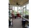 Relaxing sunroom with ceiling fan, outdoor views, and comfortable seating at 2445 N Delaware St, Indianapolis, IN 46205
