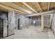 Spacious unfinished basement with visible ductwork and a hot water heater at 301 Leeds Ave, Indianapolis, IN 46201