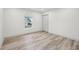 Bright bedroom featuring wood-look flooring, a window, and a closet at 301 Leeds Ave, Indianapolis, IN 46201