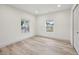 Bright bedroom featuring wood floors, neutral paint, windows with blinds, and large closet at 301 Leeds Ave, Indianapolis, IN 46201