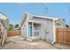 Backyard exterior featuring gray siding, a turquoise door, and a wood fence at 301 Leeds Ave, Indianapolis, IN 46201