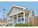 Attractive gray home featuring a covered porch with a bright blue front door at 301 Leeds Ave, Indianapolis, IN 46201