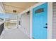 View of the front porch with a vibrant blue door and stylish lighting at 301 Leeds Ave, Indianapolis, IN 46201