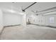 Spacious garage featuring concrete floors, white walls, and overhead lighting at 301 Leeds Ave, Indianapolis, IN 46201