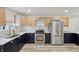 Modern kitchen includes stainless steel appliances, quartz counters, stylish cabinets, and ample counter space at 301 Leeds Ave, Indianapolis, IN 46201