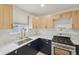 Bright and modern kitchen with stainless steel sink, stainless steel appliances and two tone cabinetry at 301 Leeds Ave, Indianapolis, IN 46201