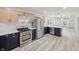 Open concept kitchen with stainless steel appliances, quartz countertops, and modern cabinets at 301 Leeds Ave, Indianapolis, IN 46201