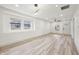 Bright, open-concept living room features modern lighting, wood floors, and lots of natural light at 301 Leeds Ave, Indianapolis, IN 46201