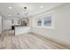 Open-concept living space with modern lighting, kitchen and bright windows at 301 Leeds Ave, Indianapolis, IN 46201
