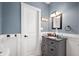 This bathroom features blue walls, a mirror, a light and a vanity at 3360 Main St, Plainfield, IN 46168