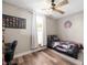 This bedroom features wood floors, a ceiling fan, one window and a bed with an American flag-themed comforter at 3360 Main St, Plainfield, IN 46168