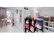 This bonus room features a vanity, a mirror, books, stuffed animals and pink floors at 3360 Main St, Plainfield, IN 46168